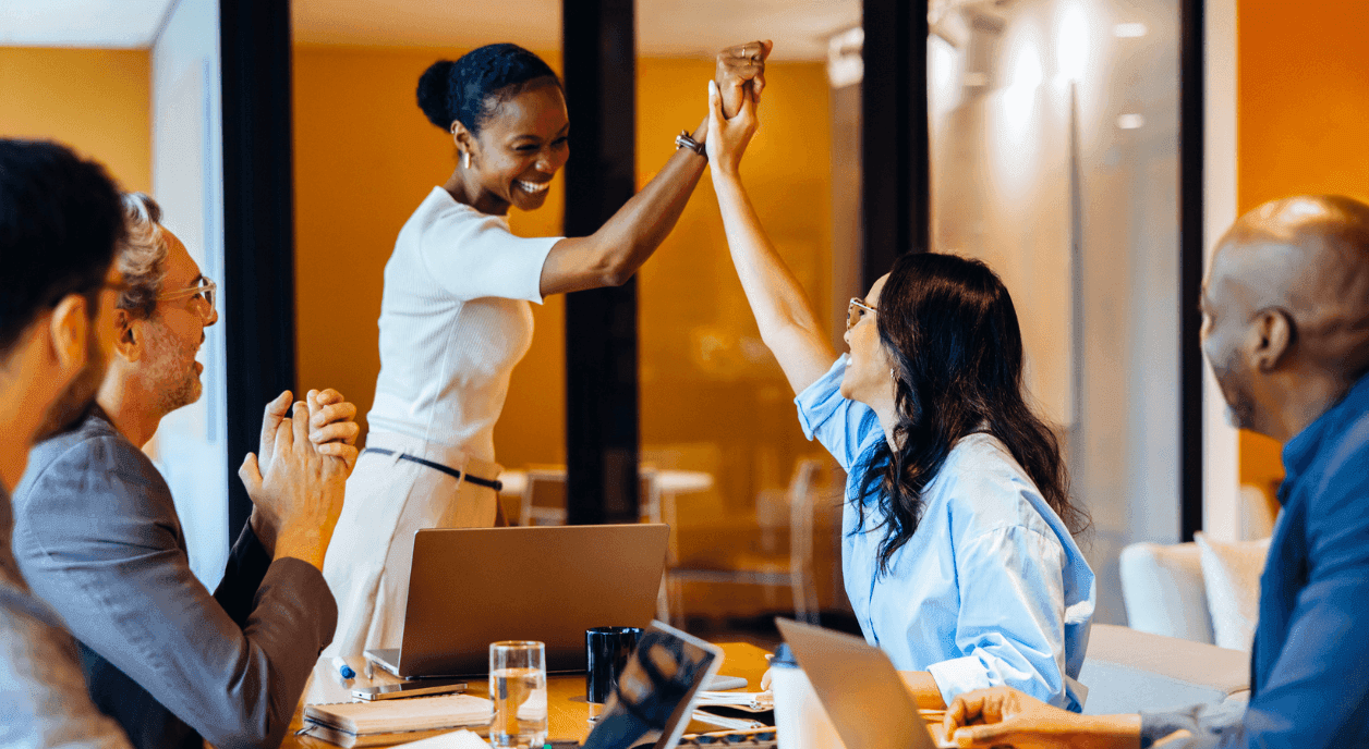 Colleagues high-fiving after receiving a DAF grant.